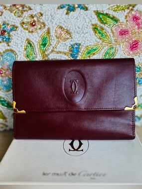 Cartier Burgundy Leather Wallet with gold accents in beautiful condition.